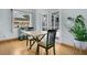 Cozy dining area with light wood floors, a bright window, and a doorway leading to the outdoors at 8603 Black Creek Blvd, Orlando, FL 32829