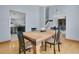 Bright dining room featuring a wooden table, hardwood floors, and seamless flow to the kitchen and other living spaces at 8603 Black Creek Blvd, Orlando, FL 32829