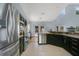 Open kitchen with stainless steel appliances, dark cabinetry, granite countertops, and easy access to the dining area at 8603 Black Creek Blvd, Orlando, FL 32829
