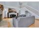 Bright living room showcasing high ceilings, a brick fireplace, a flat screen television, and a staircase leading upstairs at 8603 Black Creek Blvd, Orlando, FL 32829