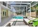 Inviting covered pool area with comfortable wicker seating, perfect for relaxation and entertaining at 8603 Black Creek Blvd, Orlando, FL 32829