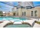 Beautiful backyard in-ground pool and spa with screened enclosure and French doors leading inside at 8603 Black Creek Blvd, Orlando, FL 32829