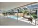 Inviting covered pool area with comfortable wicker seating, perfect for relaxation and entertaining at 8603 Black Creek Blvd, Orlando, FL 32829