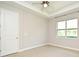 Bedroom with neutral walls, crown molding, ceiling fan, and a window at 8742 Peachtree Park Ct, Windermere, FL 34786