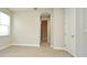Bedroom with neutral walls and carpet, arched doorway, and large window at 8742 Peachtree Park Ct, Windermere, FL 34786