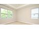 Bright bedroom with two large windows allowing natural light at 8742 Peachtree Park Ct, Windermere, FL 34786