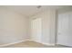 Neutral bedroom featuring a standard closet and a white door at 8742 Peachtree Park Ct, Windermere, FL 34786
