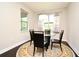 Cozy dining room featuring a glass table, four chairs, and large windows at 8742 Peachtree Park Ct, Windermere, FL 34786