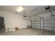 Spacious two-car garage featuring ample storage space and neutral-colored walls at 8742 Peachtree Park Ct, Windermere, FL 34786
