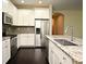 Modern kitchen features stainless steel appliances, granite countertops, and white cabinets at 8742 Peachtree Park Ct, Windermere, FL 34786