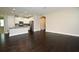 Open-concept living space with hardwood floors seamlessly connecting the living area to the kitchen at 8742 Peachtree Park Ct, Windermere, FL 34786