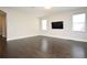 Living room with hardwood floors and neutral paint with large windows and ceiling fan at 8742 Peachtree Park Ct, Windermere, FL 34786
