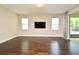 Bright living room featuring hardwood floors, neutral walls, and sliding glass doors to lanai at 8742 Peachtree Park Ct, Windermere, FL 34786