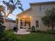 Spacious backyard with cozy outdoor seating, a grill, lush greenery, and a privacy fence for entertaining at 9573 Southern Garden Cir, Altamonte Springs, FL 32714