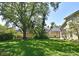 Well-maintained backyard featuring mature trees, green lawn, and a wooden fence for added privacy at 9573 Southern Garden Cir, Altamonte Springs, FL 32714