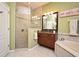 Stylish bathroom with a glass-enclosed shower, corner bathtub, and dark wood vanity at 9573 Southern Garden Cir, Altamonte Springs, FL 32714