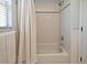Bathroom featuring a tub with tiled walls and a shower with a white shower curtain at 9573 Southern Garden Cir, Altamonte Springs, FL 32714