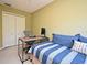 Bedroom featuring a bed, desk, office chair, and a closet with sliding doors at 9573 Southern Garden Cir, Altamonte Springs, FL 32714