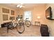 Bedroom featuring two bicycles, a mounted TV, a ceiling fan, and a large window at 9573 Southern Garden Cir, Altamonte Springs, FL 32714