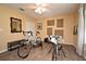 Bedroom featuring two bicycles, wood floors, wall decorations, and a ceiling fan at 9573 Southern Garden Cir, Altamonte Springs, FL 32714
