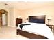 Inviting bedroom with a dark wood bed, neutral walls, and view into an ensuite bathroom at 9573 Southern Garden Cir, Altamonte Springs, FL 32714