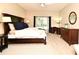 Bright bedroom with a bed, desk area, light wood flooring, and a sunny window at 9573 Southern Garden Cir, Altamonte Springs, FL 32714