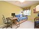 Cozy bedroom featuring a daybed, desk, large window, and bright natural light at 9573 Southern Garden Cir, Altamonte Springs, FL 32714