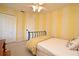 A charming bedroom with yellow and white striped walls, ceiling fan, and a cozy bed at 9573 Southern Garden Cir, Altamonte Springs, FL 32714