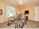 Bedroom with two bicycles, natural light, wood floors, and a ceiling fan at 9573 Southern Garden Cir, Altamonte Springs, FL 32714