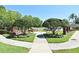 Community park has benches, trees, and walkways with flowers for residents to enjoy at 9573 Southern Garden Cir, Altamonte Springs, FL 32714