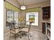 Cozy dining area with bright windows, custom valances and a glass table, perfect for casual meals at 9573 Southern Garden Cir, Altamonte Springs, FL 32714