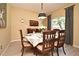 Formal dining room featuring a traditional table setting, elegant chandelier, and large window at 9573 Southern Garden Cir, Altamonte Springs, FL 32714