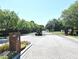 Gated community entrance with brick pillars, lush landscaping, and a secure entry system at 9573 Southern Garden Cir, Altamonte Springs, FL 32714