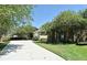 Charming single-story home featuring a long driveway, lush landscaping, and attached garage at 9573 Southern Garden Cir, Altamonte Springs, FL 32714