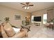 Inviting living room with a comfortable leather sofa, tile floors, and a view of the exterior through bright windows at 9573 Southern Garden Cir, Altamonte Springs, FL 32714