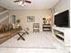 Bright and airy living room featuring a comfortable leather sofa, tile floors, and staircase access to the second floor at 9573 Southern Garden Cir, Altamonte Springs, FL 32714