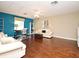 Bright living room with hardwood floors, a ceiling fan, and large windows that provide natural light at 9573 Southern Garden Cir, Altamonte Springs, FL 32714