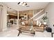 Spacious living room area with a leather sofa, open floor plan, connecting to a kitchen and dining area, and a staircase at 9573 Southern Garden Cir, Altamonte Springs, FL 32714