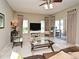 Bright living room with tile floors, cozy seating, natural light, and a view of the outdoor patio through sliding glass doors at 9573 Southern Garden Cir, Altamonte Springs, FL 32714