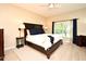 Main bedroom with a large bed, neutral tones, and ample natural light from the window at 9573 Southern Garden Cir, Altamonte Springs, FL 32714