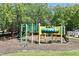 Community playground features a fun, colorful climbing structure and slide for children at 9573 Southern Garden Cir, Altamonte Springs, FL 32714