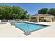 Community swimming pool featuring lounge chairs, a shaded pavilion, and mature trees at 9573 Southern Garden Cir, Altamonte Springs, FL 32714