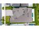 Aerial view of the rear of a home with a pool, manicured lawn, and landscaping at 1005 Talon Pl, Winter Springs, FL 32708