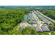 An aerial view of a planned community with multiple homes and a community pond at 1005 Talon Pl, Winter Springs, FL 32708