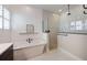 Elegant bathroom featuring a standalone tub, plantation shutters, and a modern shower at 1005 Talon Pl, Winter Springs, FL 32708