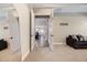 Comfortable bedroom featuring neutral carpeting, a gray sofa, and a full-length mirror at 1005 Talon Pl, Winter Springs, FL 32708