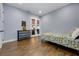 This bedroom has wood flooring, a closet, and French doors at 1005 Talon Pl, Winter Springs, FL 32708