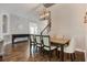 Light-filled dining room featuring hardwood floors, a statement chandelier, and seating for six at 1005 Talon Pl, Winter Springs, FL 32708