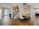 Spacious dining area featuring hardwood floors, decorative lighting, and staircase access to the second floor at 1005 Talon Pl, Winter Springs, FL 32708