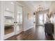Bright foyer with hardwood floors, decorative lighting, and a bedroom visible through glass doors at 1005 Talon Pl, Winter Springs, FL 32708